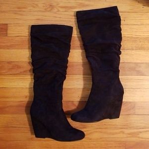 Tall black wedged zip up boots
